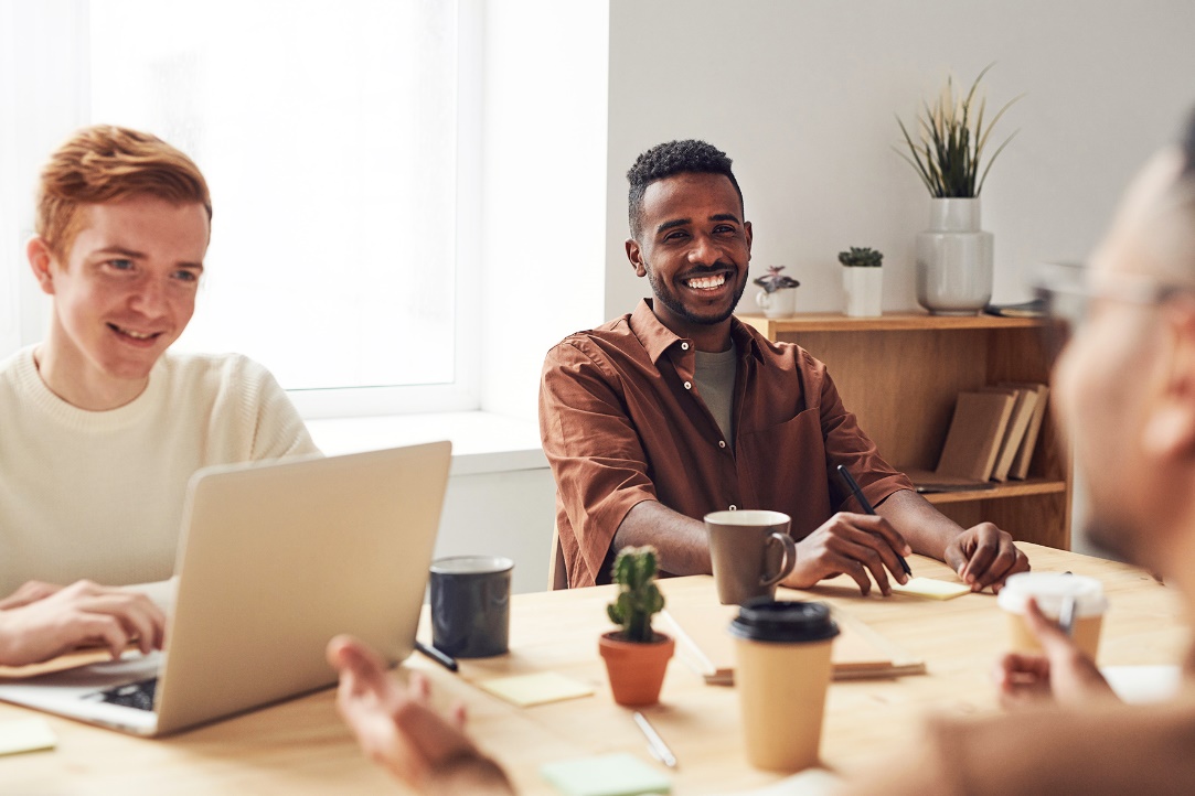 Men at table with laptops